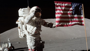 Apollo 17 Astronaut Eugene A. Cernan standing next to the US Flag on the moon 