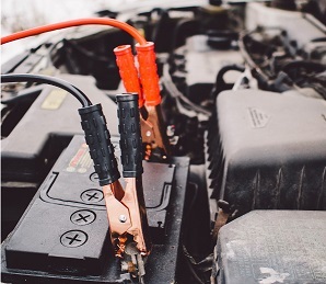 Picture of person jump starting a car with a flat 12v battery